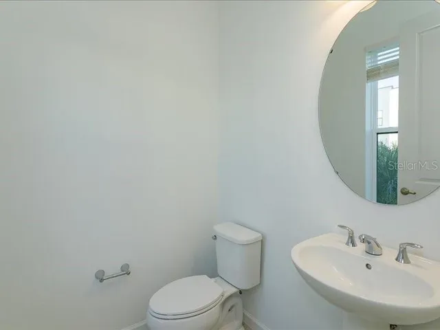 a white toilet sitting next to a white sink