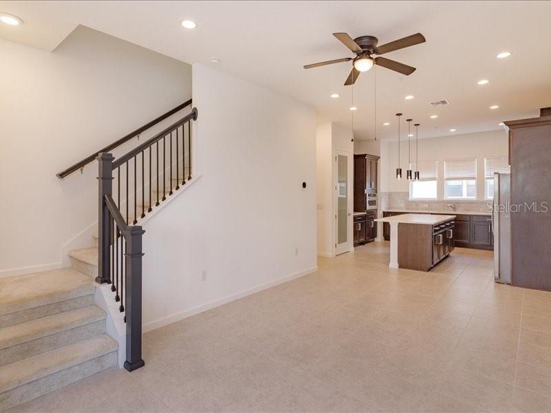 2353 Brix Street Orlando, FL 32804 - Photo 8 of 25 a open kitchen with stainless steel appliances a refrigerator a sink dishwasher with a dining table and chairs