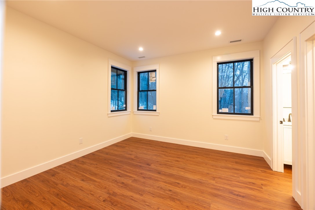 131 Bryce Way Boone, NC 28607 - Photo 17 of 38 a view of an empty room with wooden floor and a window