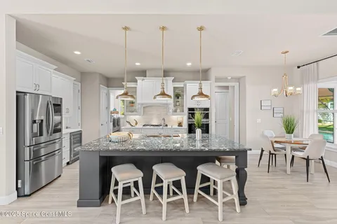 a kitchen with stainless steel appliances wooden cabinets and a stove