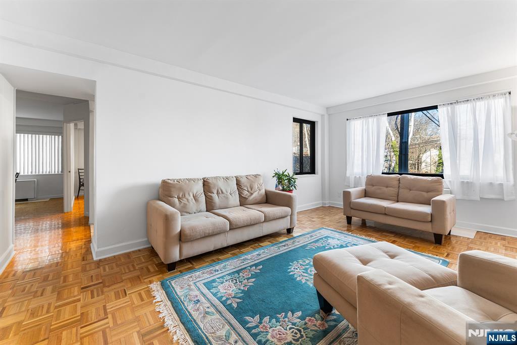 1375 River Road, Unit 1K Edgewater, NJ 07020 - Photo 11 of 27 a living room with furniture and a rug