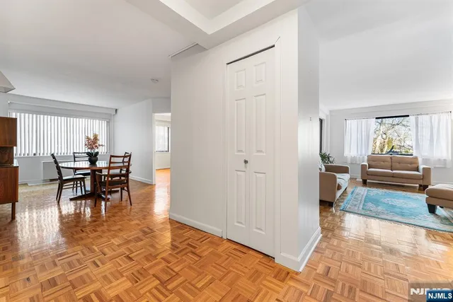 a living room with furniture and a dining table with kitchen view