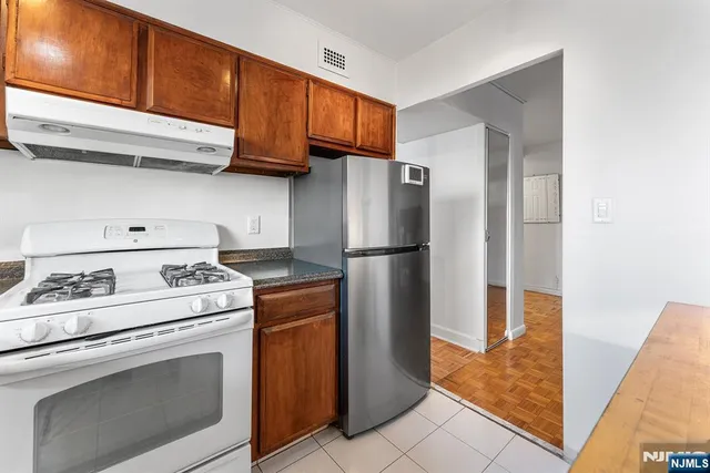 a kitchen with appliances cabinets and a counter top space