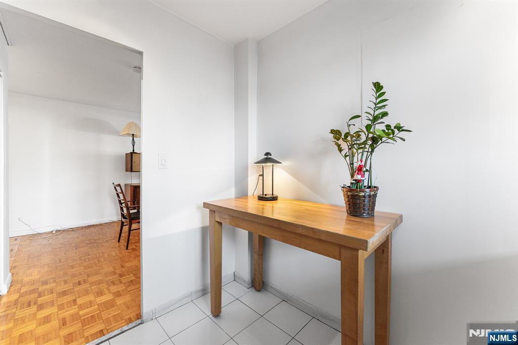 1375 River Road, Unit 1K Edgewater, NJ 07020 - Photo 21 of 27 a table room with chair and flower pot