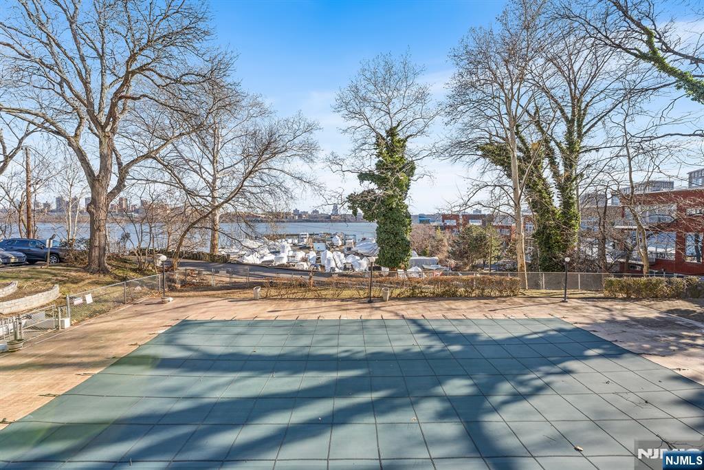 1375 River Road, Unit 1K Edgewater, NJ 07020 - Photo 25 of 27 a view of a yard with snow on the road