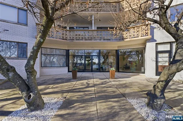 a view of a building with a tree in front of it