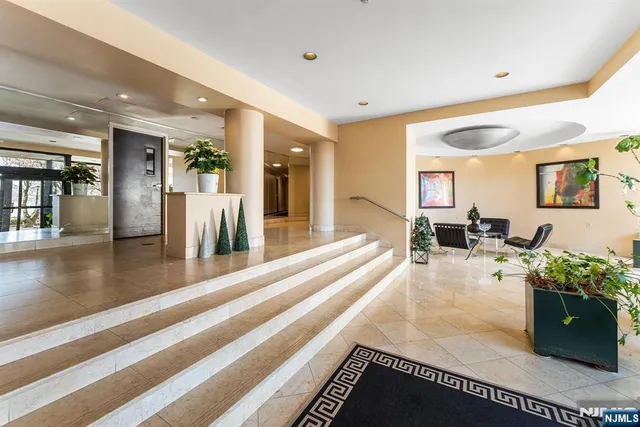 a lobby with furniture and a potted plant