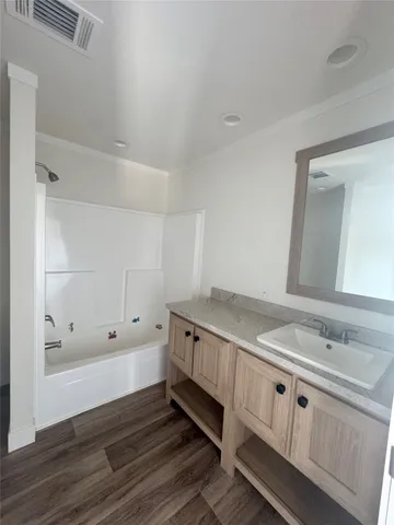 a bathroom with double vanity and a mirror