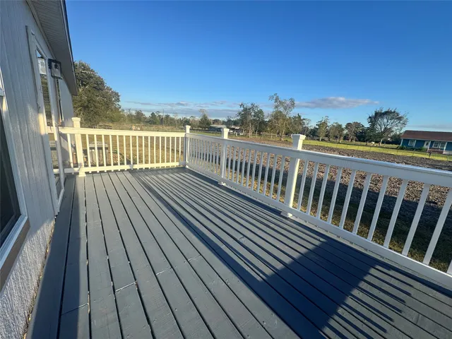 a view of balcony with wooden floor