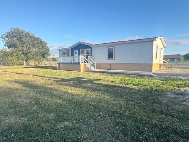a house view with swimming pool in front of it