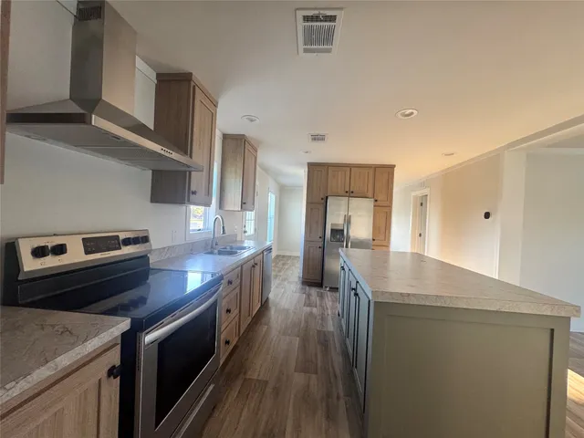a kitchen with a stove and a refrigerator