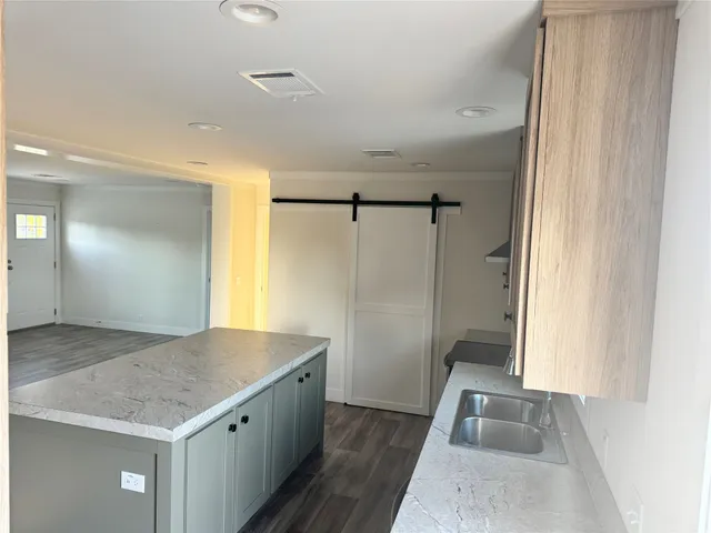 a bathroom with a granite countertop sink and shower