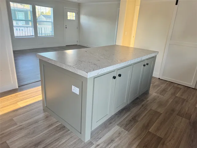 a view hallway with wooden floor and window