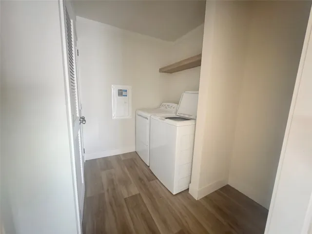 a view of utility room with wooden floor