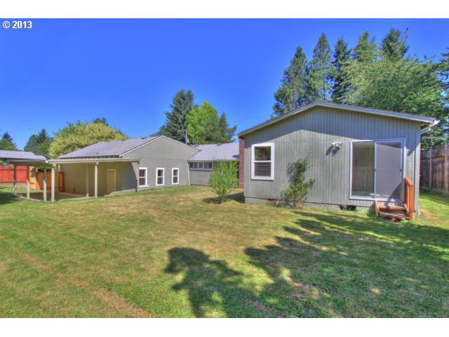 8880 Southwest Garden Home Road Portland, OR 97223 - Photo 3 of 13 a big house with a big yard and large trees