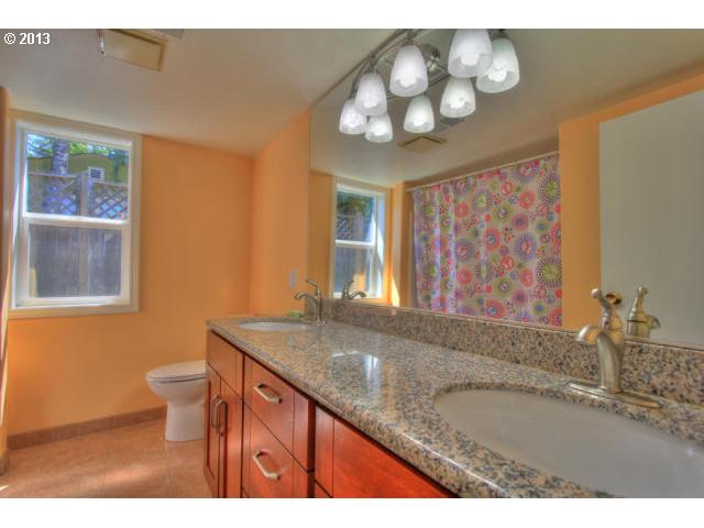 8880 Southwest Garden Home Road Portland, OR 97223 - Photo 7 of 13 a bathroom with a granite countertop sink a toilet and a large mirror