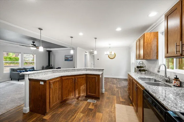 a kitchen with a stove sink and cabinets
