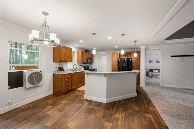 a large kitchen with a wooden floor and a large window