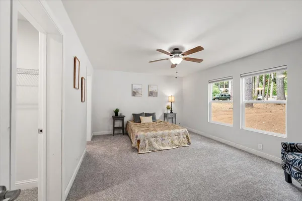 a spacious bedroom with a bed and a window