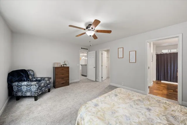 a bedroom with a bed and ceiling fan