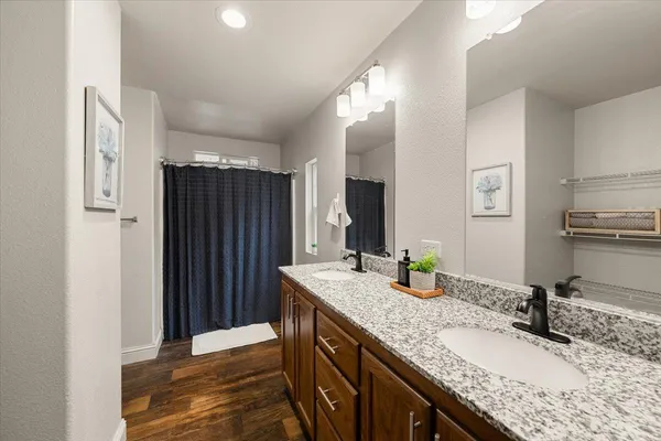 a bathroom with a granite countertop sink and a mirror