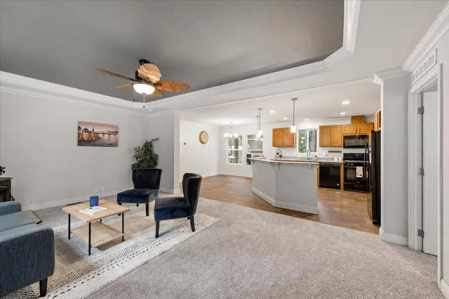 a living room with furniture and kitchen view