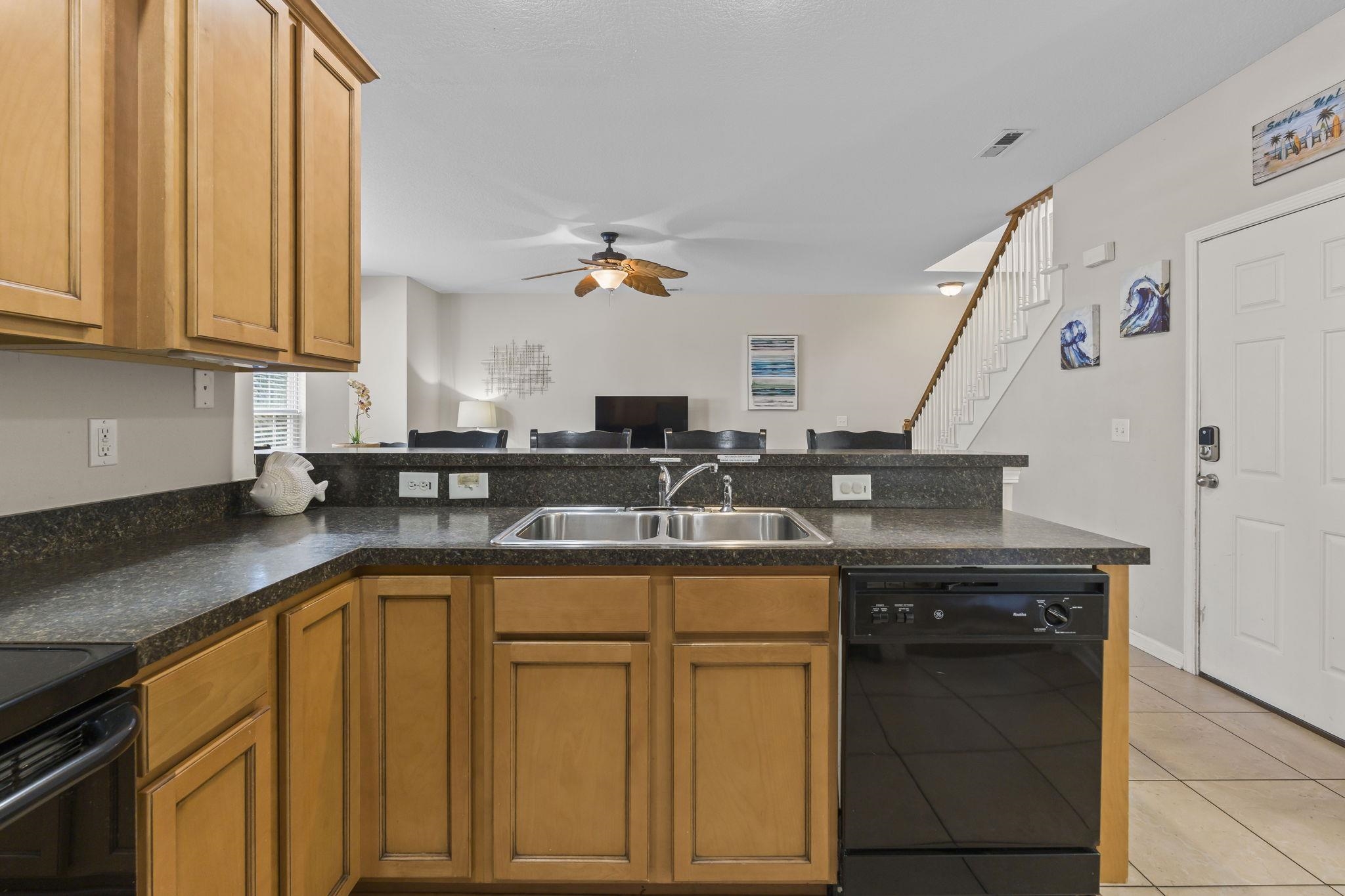 311 B 3rd Avenue North Surfside Beach, SC 29575 - Photo 12 of 39 Kitchen featuring black appliances, dark countertops, a peninsula, and brown cabinets