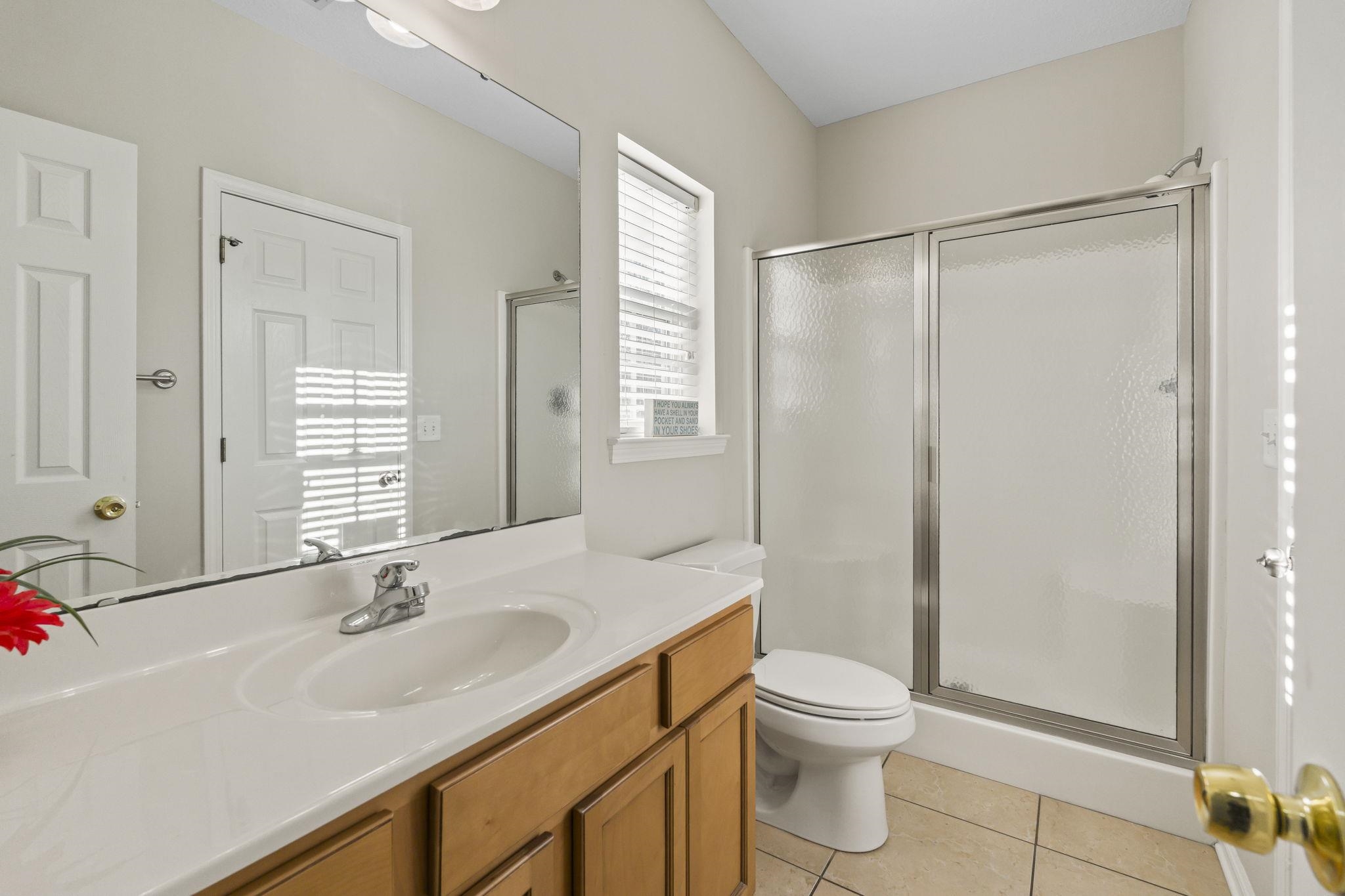311 B 3rd Avenue North Surfside Beach, SC 29575 - Photo 17 of 39 Bathroom featuring a stall shower, vanity, and light tile patterned floors