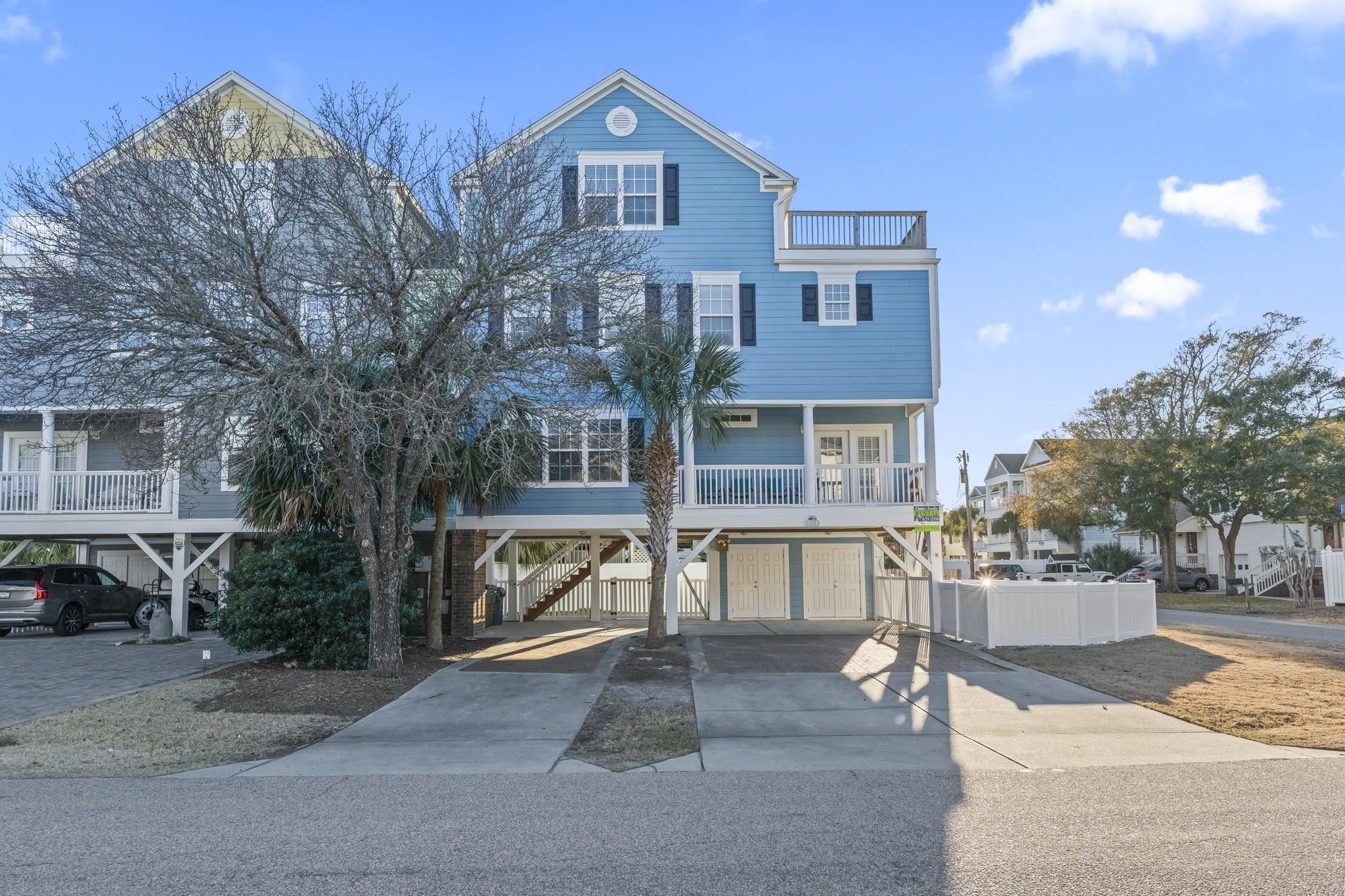 311 B 3rd Avenue North Surfside Beach, SC 29575 - Photo 2 of 39 Coastal home featuring a carport, stairway, and concrete driveway