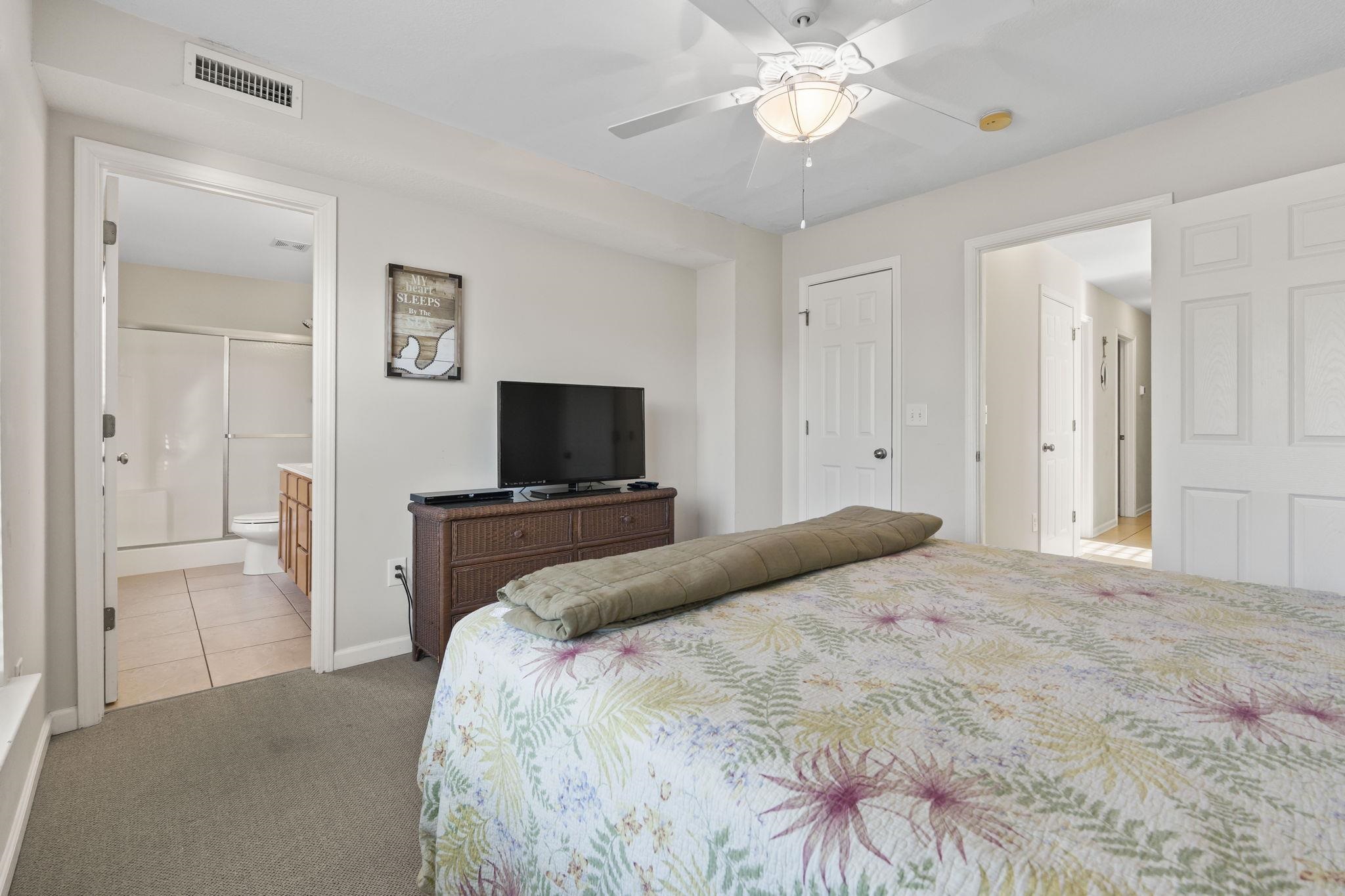 311 B 3rd Avenue North Surfside Beach, SC 29575 - Photo 23 of 39 Bedroom featuring carpet floors, ceiling fan, ensuite bath, and tile patterned floors