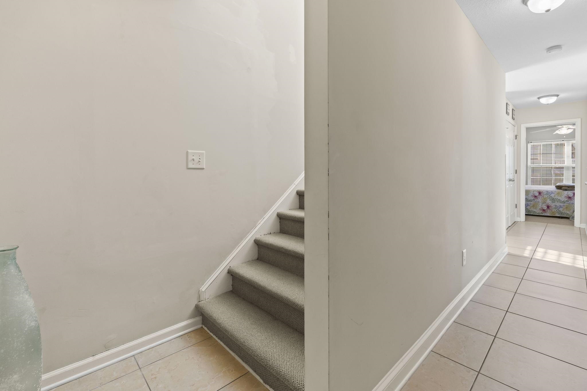 311 B 3rd Avenue North Surfside Beach, SC 29575 - Photo 32 of 39 Stairway with tile patterned floors and a ceiling fan