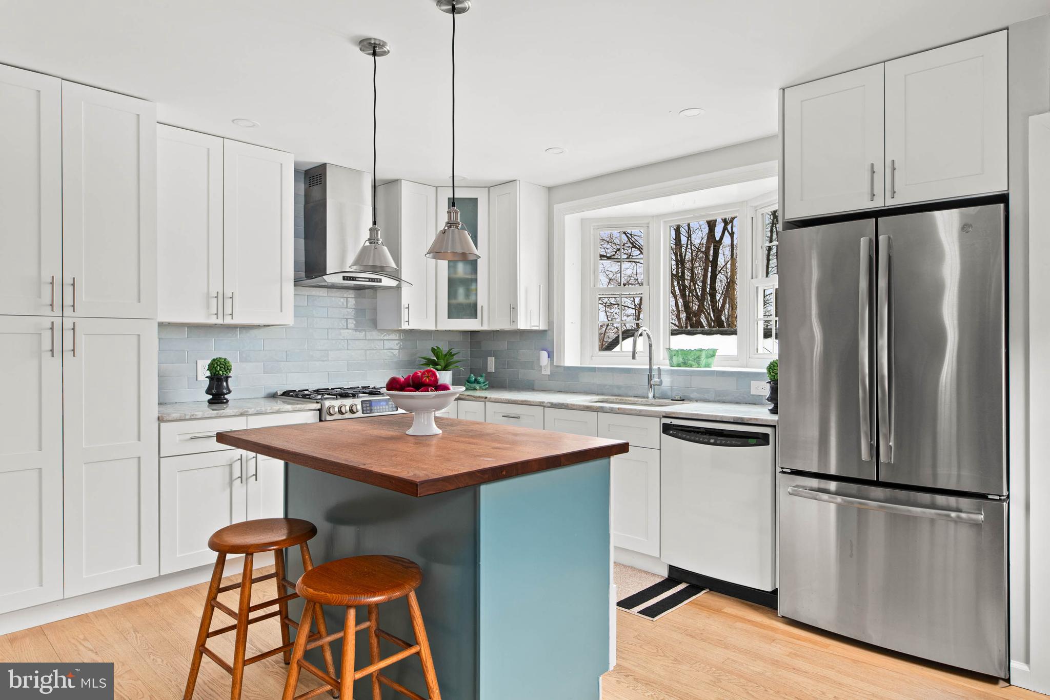 444 St Davids Avenue Wayne, PA 19087 - Photo 11 of 28 a kitchen with stainless steel appliances granite countertop a refrigerator a sink a stove and white cabinets with wooden floor