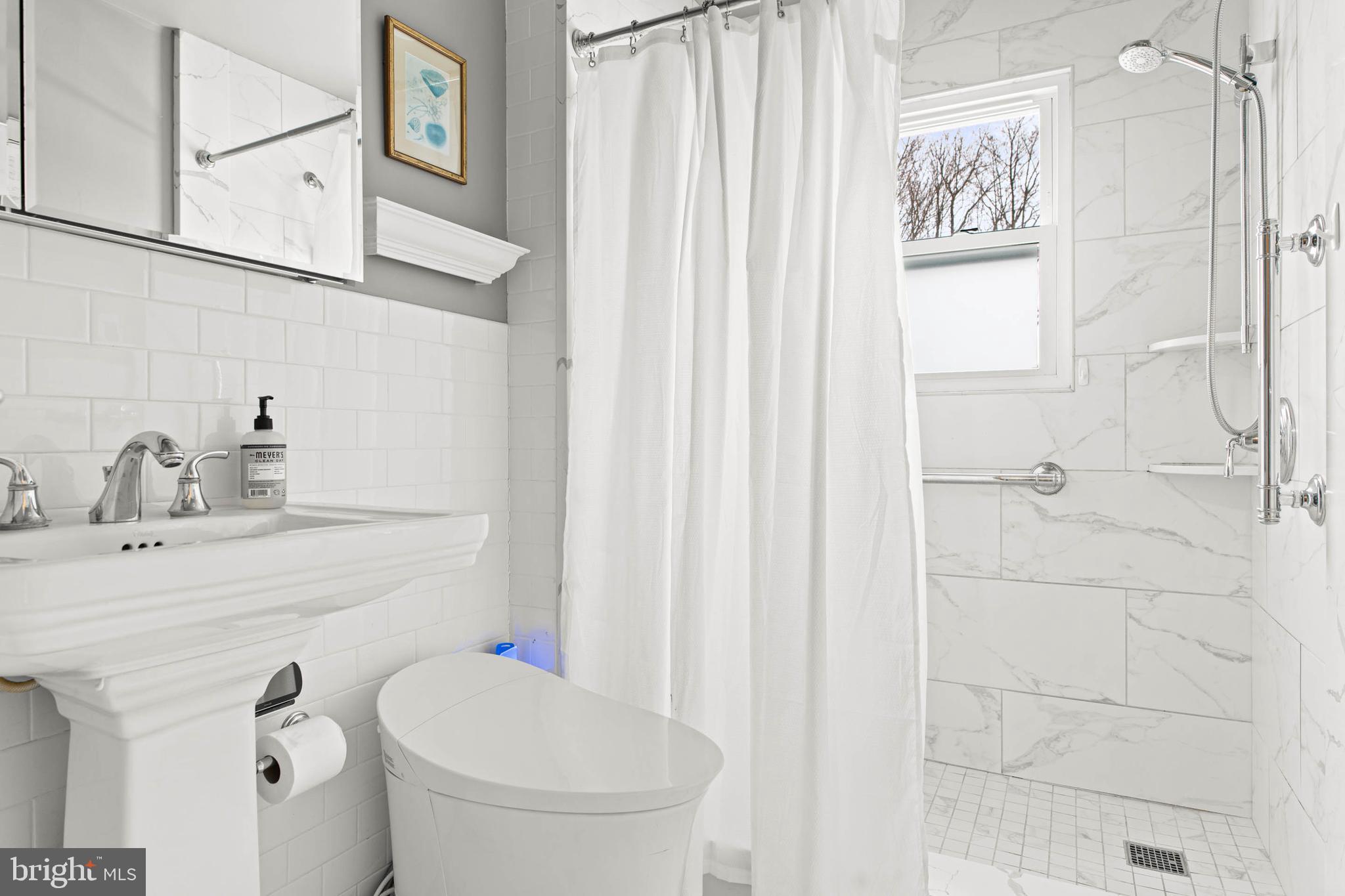 444 St Davids Avenue Wayne, PA 19087 - Photo 17 of 28 a bathroom with a sink a toilet and shower curtain