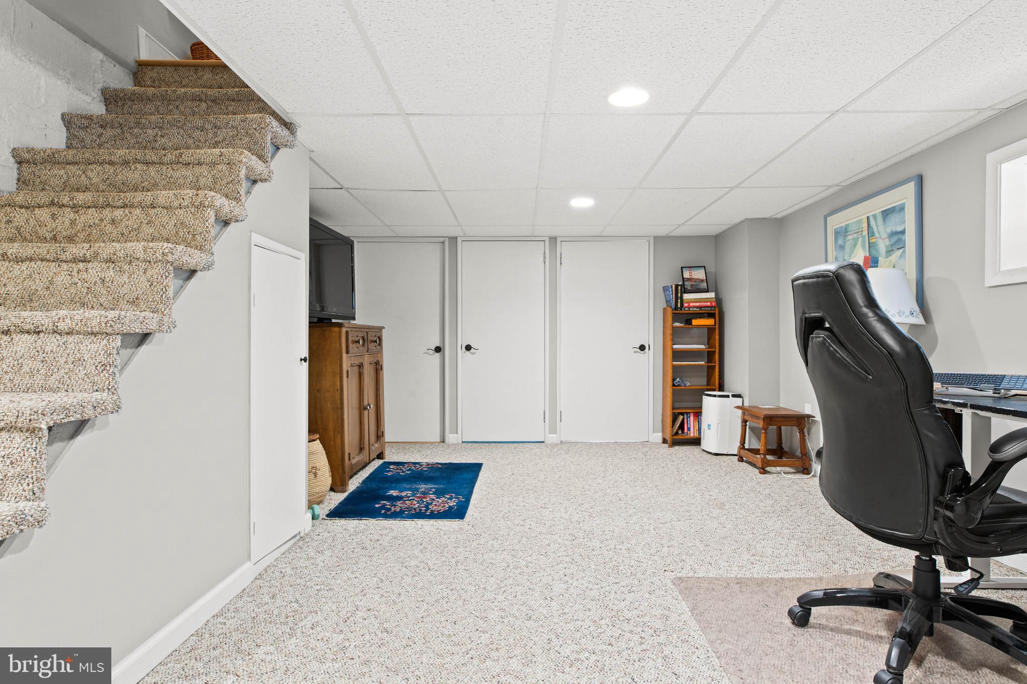 444 St Davids Avenue Wayne, PA 19087 - Photo 22 of 28 a view of a hallway with workspace and gym equipment