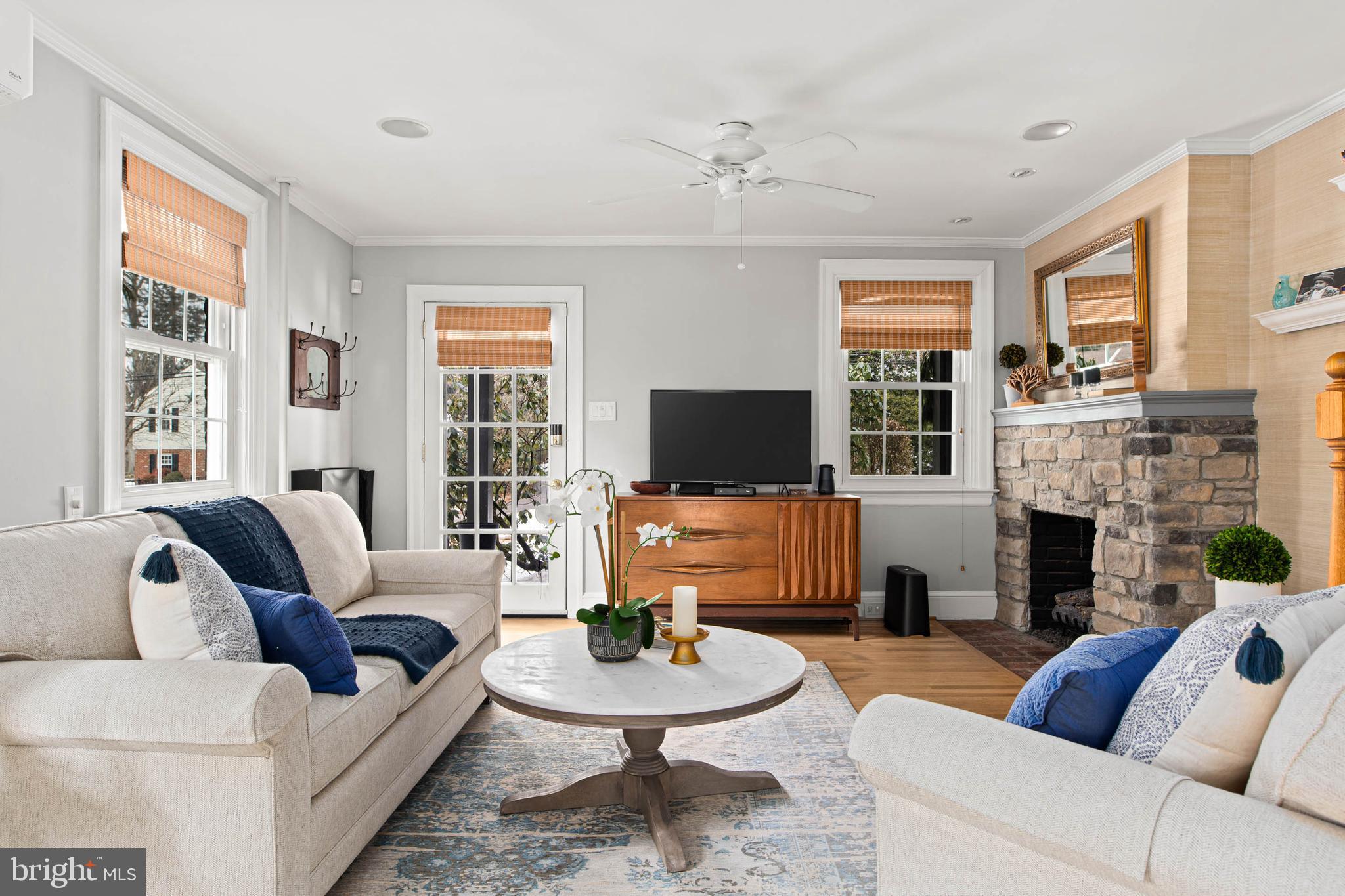 444 St Davids Avenue Wayne, PA 19087 - Photo 3 of 28 a living room with furniture a flat screen tv and a fireplace