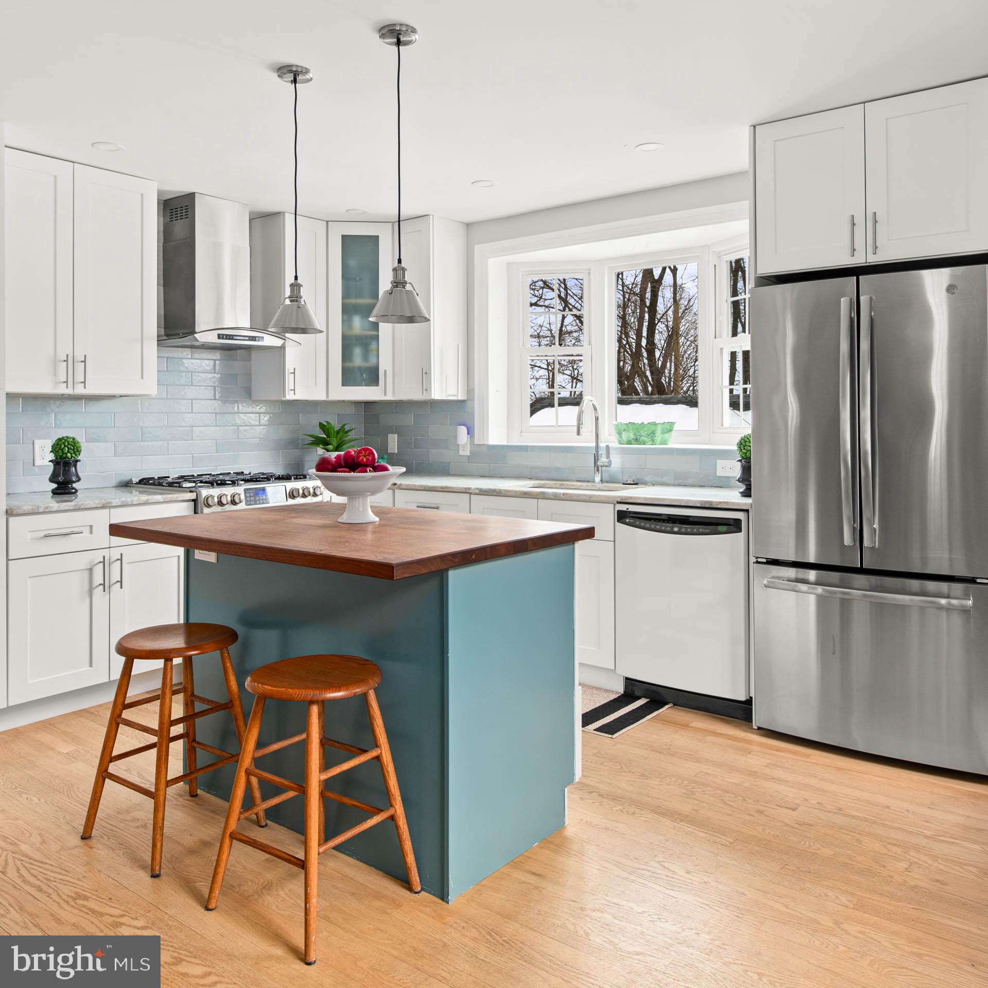 444 St Davids Avenue Wayne, PA 19087 - Photo 8 of 28 a kitchen with stainless steel appliances granite countertop a sink stove and refrigerator