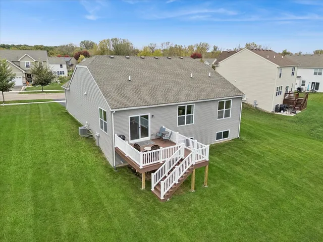 a aerial view of a house with a yard table and chairs