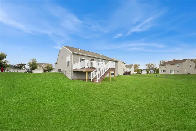 a view of a house with a yard and garage