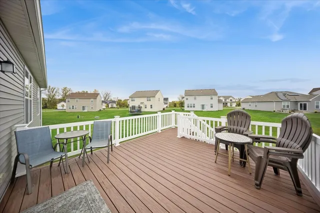 a view of a chairs and table on the wooden deck