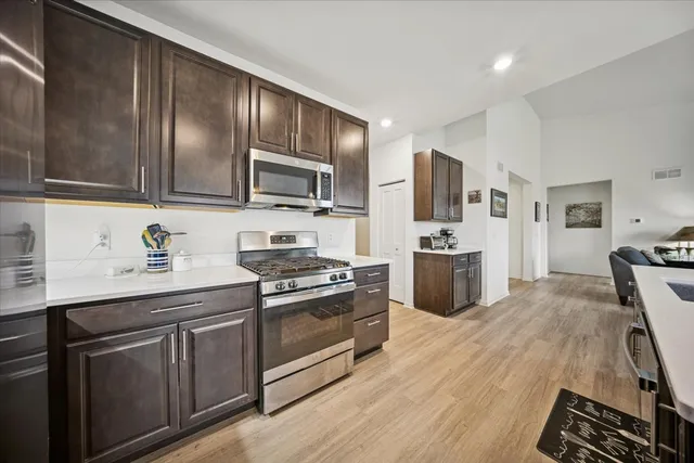 a kitchen with stainless steel appliances a sink stove and refrigerator