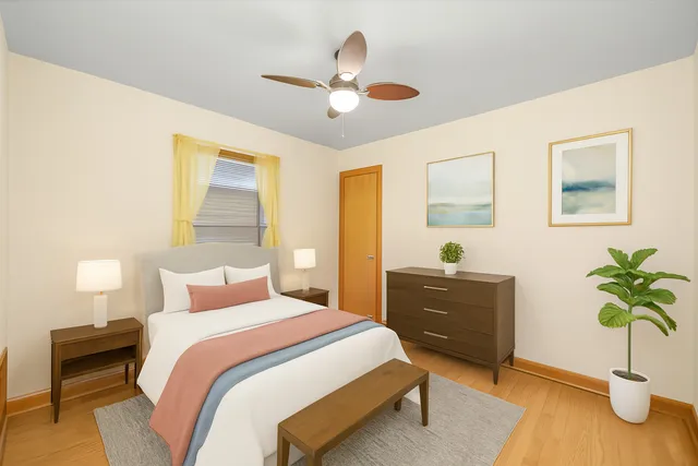 a bedroom with a bed and a potted plant