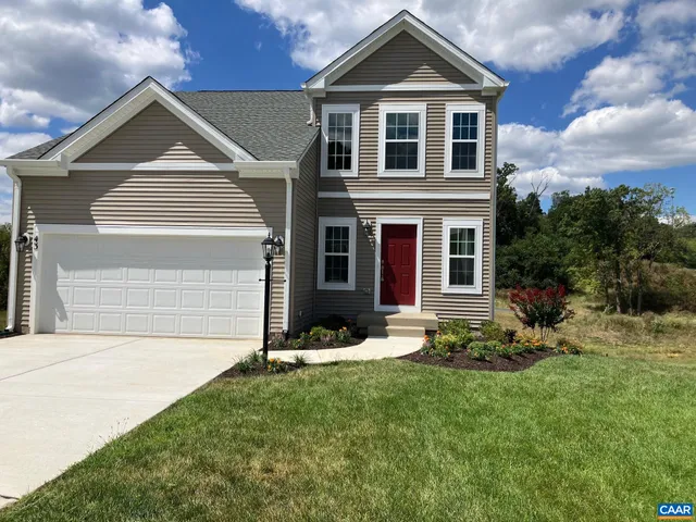 a front view of a house with a yard and pathway