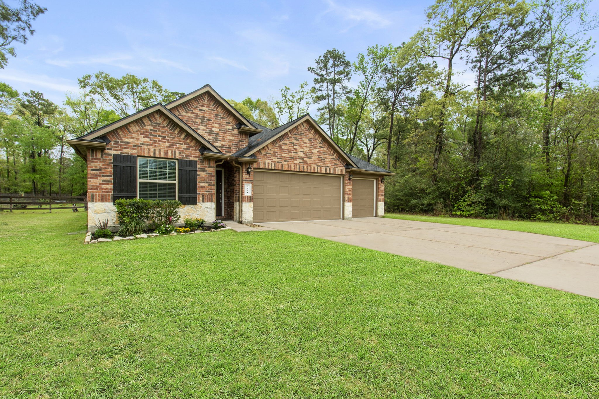 4551 Axis Trail Conroe, TX 77303 - Photo 2 of 12 a front view of house with yard and green space