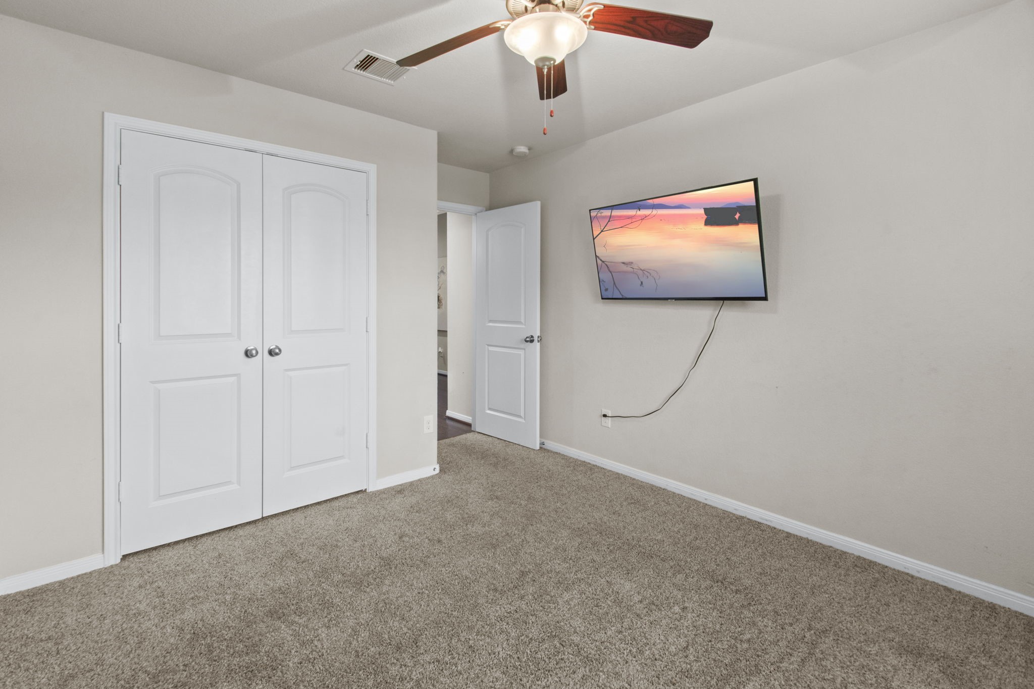 4551 Axis Trail Conroe, TX 77303 - Photo 3 of 12 en empty room with window and ceiling fan