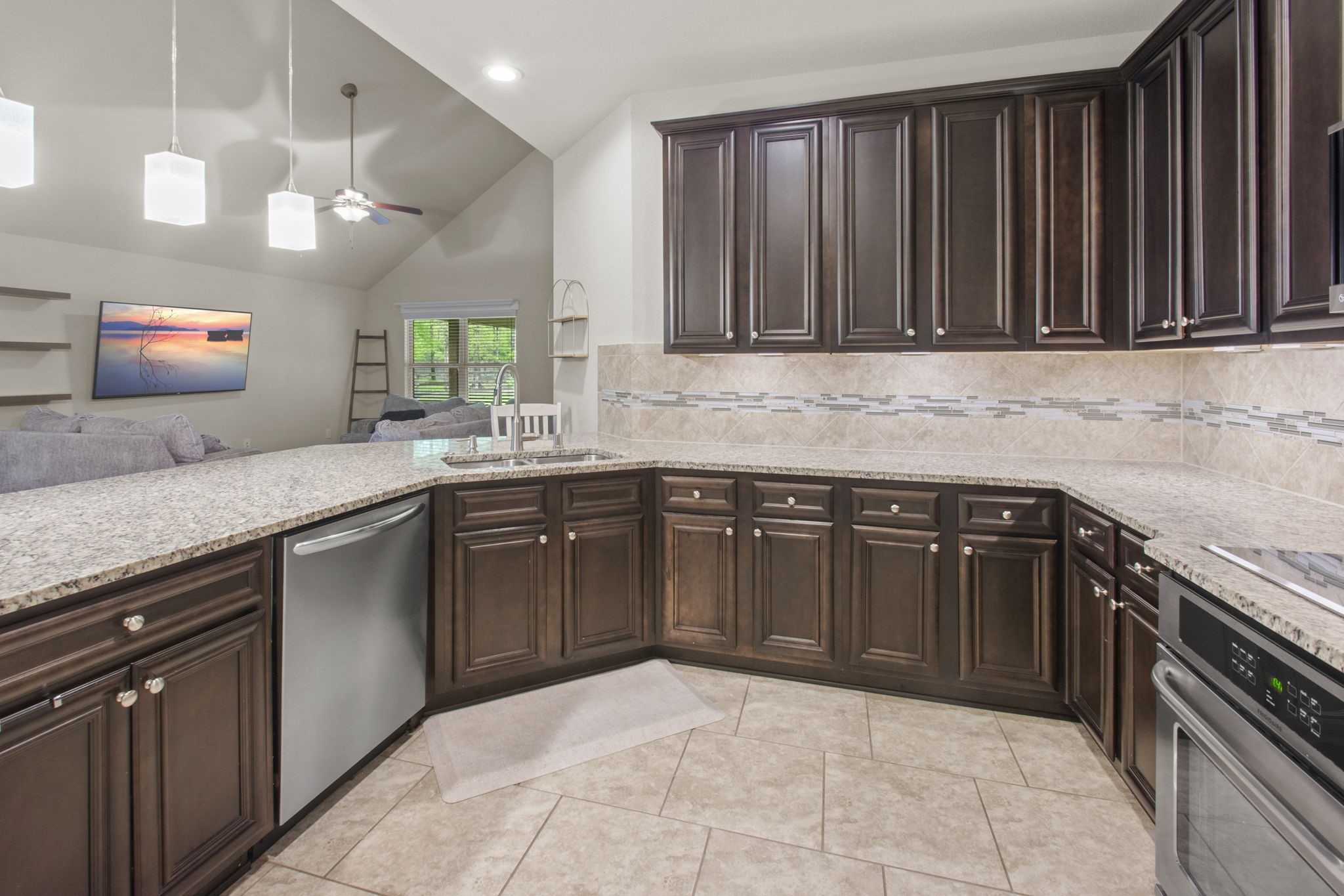 4551 Axis Trail Conroe, TX 77303 - Photo 7 of 12 a kitchen with stainless steel appliances granite countertop a sink stove and cabinets