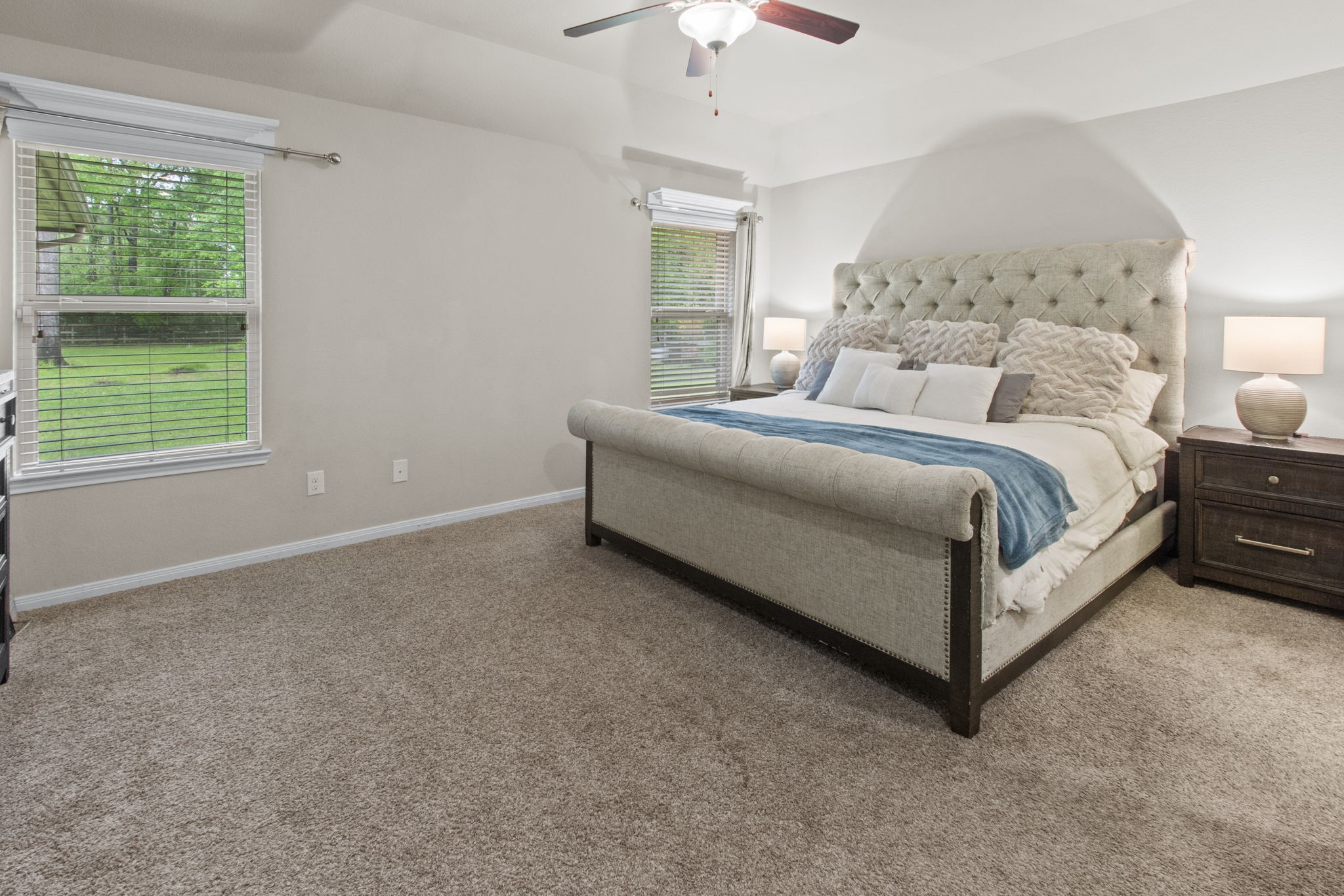 4551 Axis Trail Conroe, TX 77303 - Photo 9 of 12 a spacious bedroom with a bed and a window
