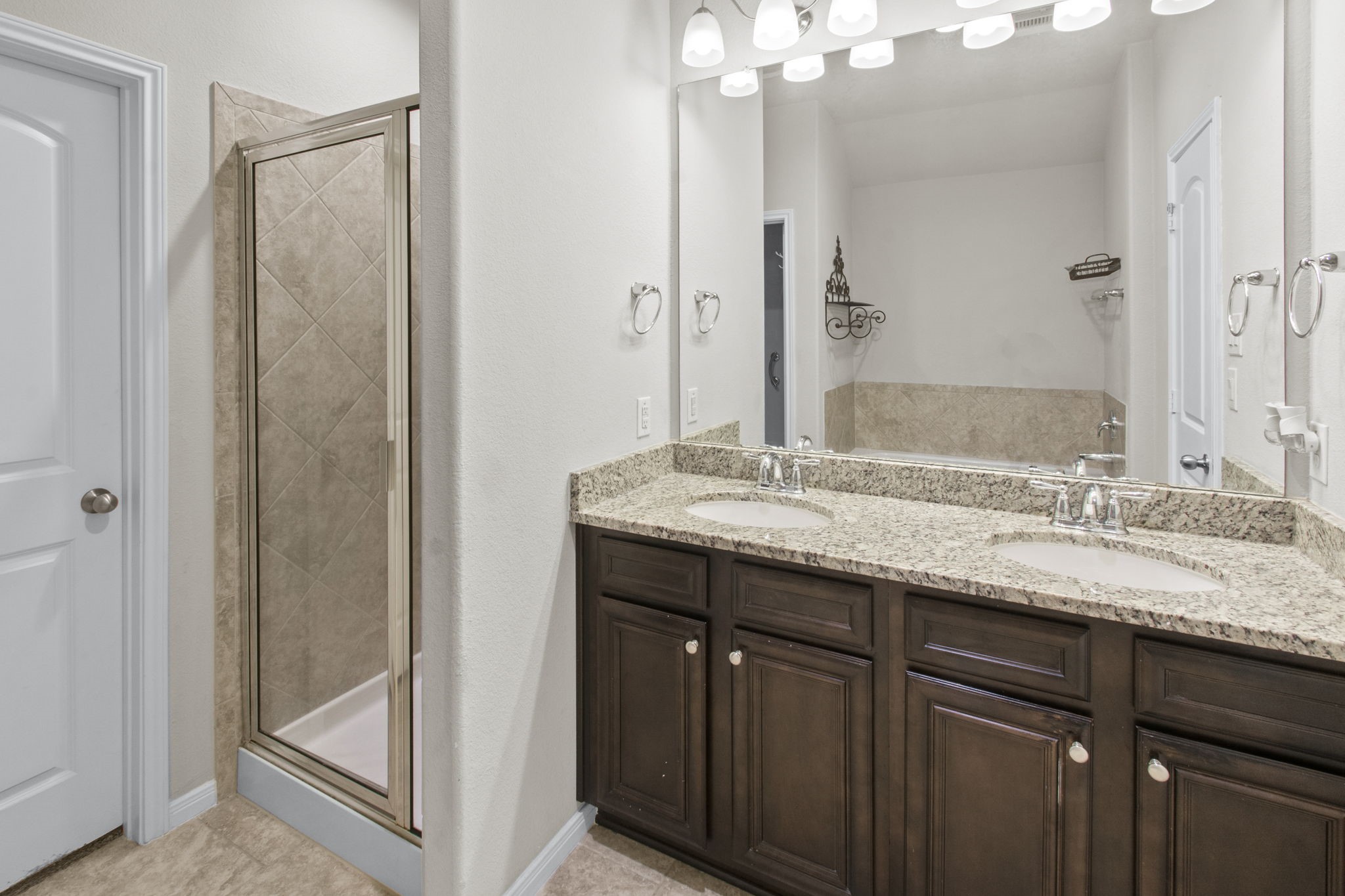 4551 Axis Trail Conroe, TX 77303 - Photo 10 of 12 a bathroom with a granite countertop sink and a mirror