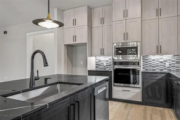 a kitchen with kitchen island a sink stove and oven