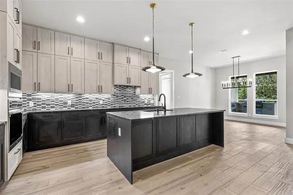 a kitchen with stainless steel appliances granite countertop a stove sink and cabinets