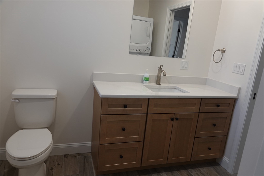 6 Pondover Road, Unit ADU Billerica, MA 01821 - Photo 11 of 20 a bathroom with a toilet sink vanity and mirror